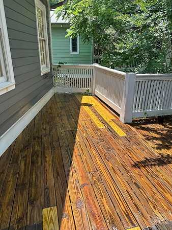 How can deck and fence cleaning help extend the life of outdoor wood